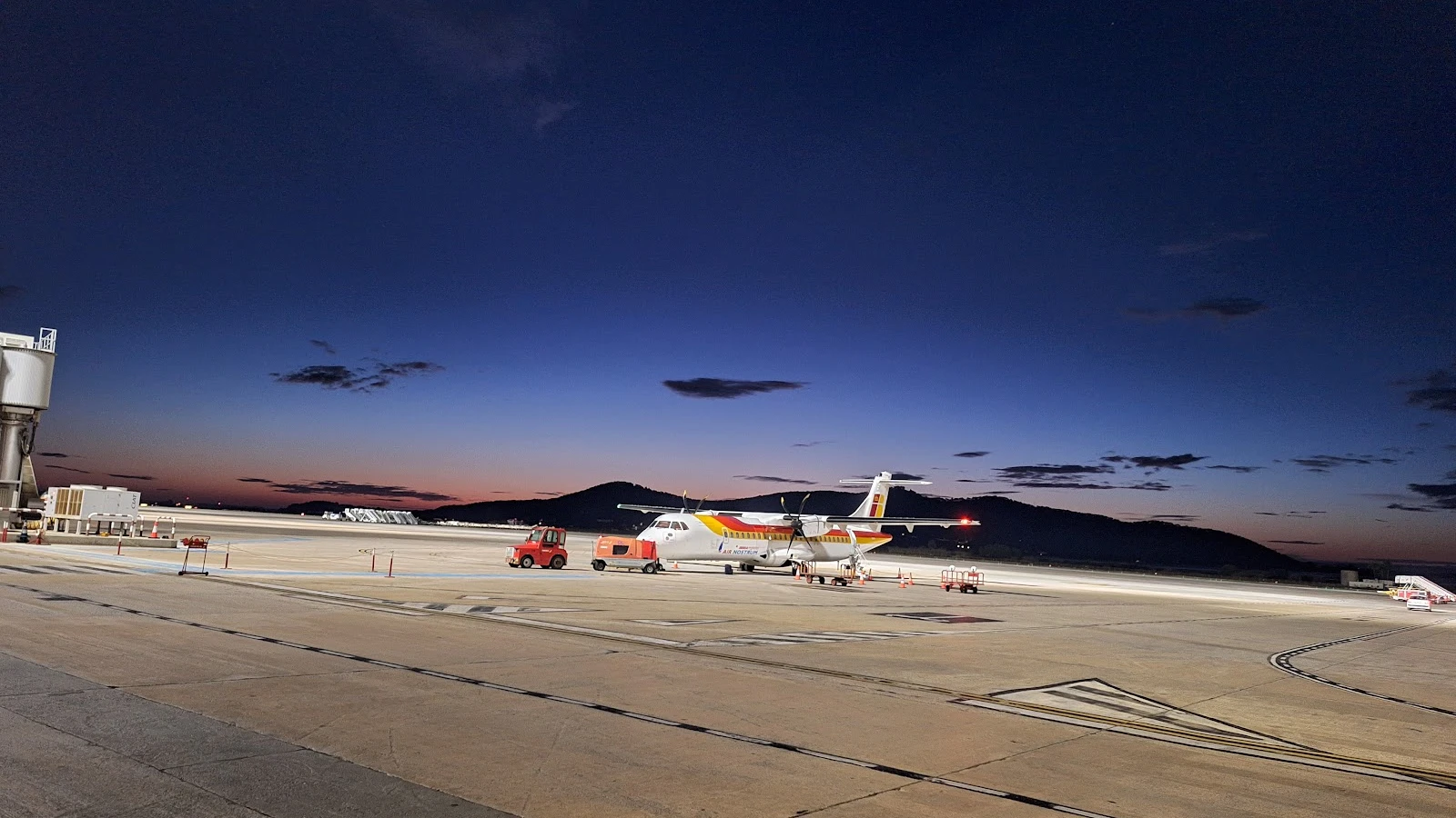 Ibiza Airport terminal arrivals area with car rental pickup zone